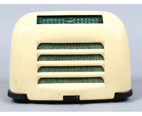 A vintage white bakelite KB radio.