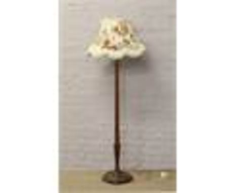 A mahogany standard lamp with reeded column and floral shade.