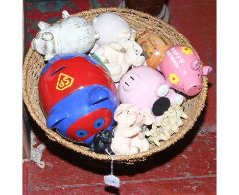 A standing basket of ceramic pig penny banks etc.
