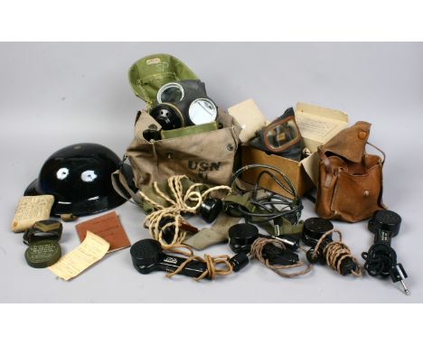 A quantity of militaria including boxed British gas masks, helmet, hand held microphones, radio headphones, soldiers service 