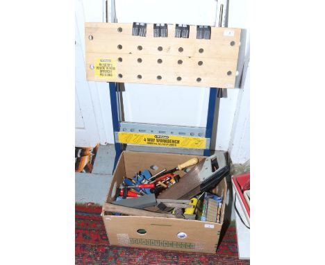 A box of hand tools to include saws, chisels, clamps, blade sharpener etc, along with a 4 way workbench.