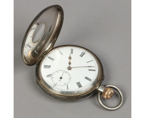 A Swiss silver half hunter pocket watch with white enamel dial, Roman numeral markers and subsidiary seconds.