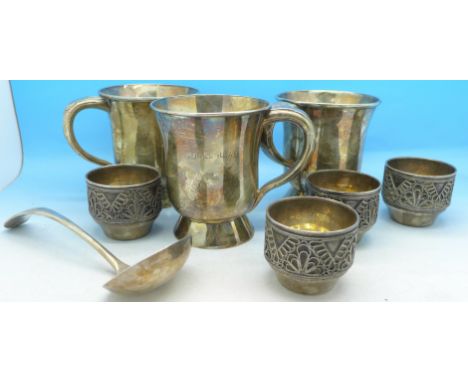 Three plated mugs marked Turks Head, two marked Nottingham on the bases, four white metal salts and a plated ladle