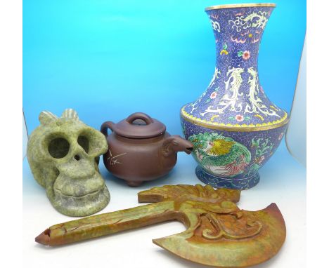 A metal and enamel oriental vase, a terracotta teapot, a carved stone skull and a carved soapstone axe