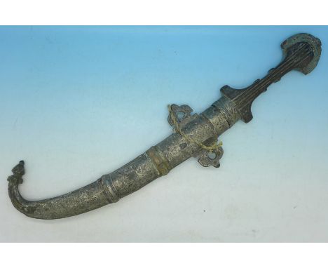 A Middle Eastern dagger with white metal covered scabbard