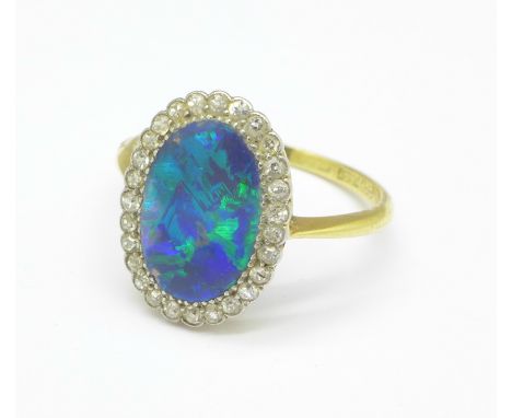 An 18ct gold, diamond and opal ring, two very small chips to side of opal, opal approximately 13mm x 8mm, 2.9g, S