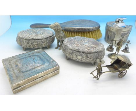 A silver hand brush, a horseshoe shaped table lighter, a pair of embossed trinket boxes, a white metal box, Chinese figures a