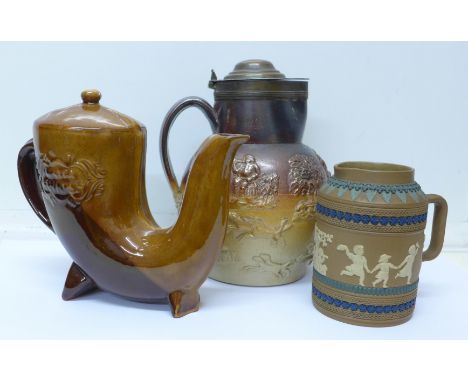 A Doulton Lambeth silicon relief moulded jug, a large relief moulded stoneware jug with hunting and tavern scenes and a Russi