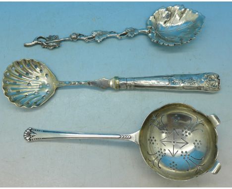 A silver tea strainer, Sheffield 1956, Cooper Brothers & Son Ltd., a silver leaf spoon marked 925 and a silver handled sifter