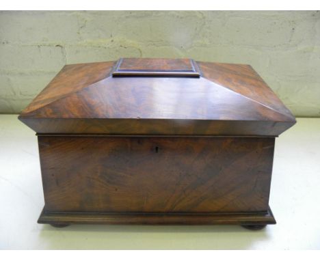 A VICTORIAN MAHOGANY TEA CADDY OF SARCOPHAGUS SHAPE COMPLETE WITH THE THREE ORIGINAL MAHOGANY TEA CANNISTERS