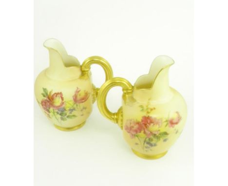 A PAIR OF ROYAL WORCESTER FLAT BACK JUGS PRINTED AND PAINTED WITH NATURALISTIC FLOWERS ON A SHADED APRICOT GROUND, PRINTED MA