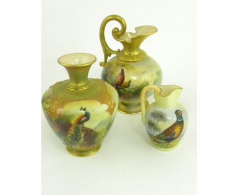 A ROYAL WORCESTER EWER AND SIMILAR ROYAL WORCESTER VASE, PRINTED AND PAINTED WITH PHEASANTS OR A PEACOCK IN MOULDED GILT BORD