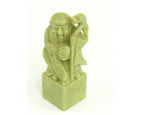 A CHINESE CARVED GREEN HARDSTONE SEAL IN THE FORM OF SHOULAO