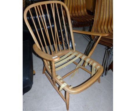 An Ercol light elm stick back armchair (seat support a.f.)