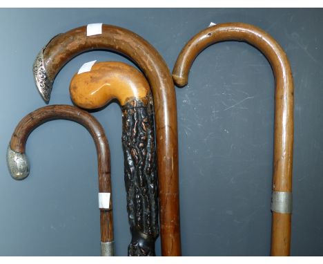 Three silver mounted walking canes; a brier walking cane; an antler handle walking cane; a stick stand; an aneroid barometer 