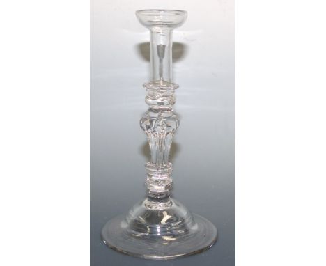 An 18th century mid Georgian glass taper stick with knopped stem on domed circular foot