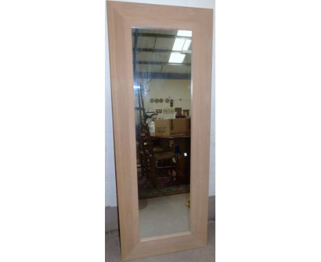 A modern limed light oak framed rectangular wall mirror