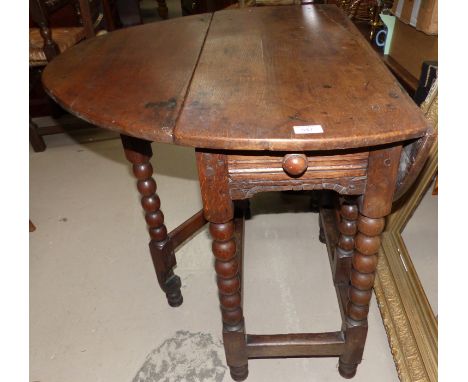 An 18th century drop leaf occasional/dining table on bobbin turned legs, fitted single drawer