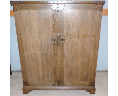 An oak medieval style press cupboard enclosed by 2 doors, fretted brass mounts, part fitted interior with 5 sliding trays, on