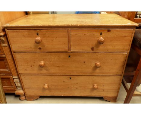 A rustic pine chest of 2 long and 2 short drawers, with bobbin handles, height 38"
