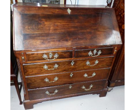 An 18th century stained chestnut bureau with fall front, serpentine stepped interior, 2 long and 3 short drawers below with o