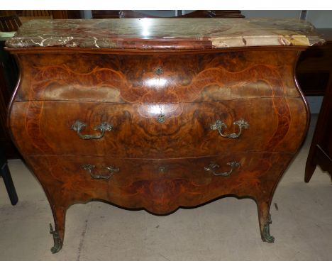 A late 19th/early 20th century Italian bombé commode of 3 drawers, with extensive marquetry decoration and ormolu handles and