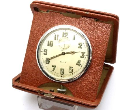 Leather cased Cyma travelling clock, working at lotting. P&amp;P Group 2 (£18+VAT for the first lot and £3+VAT for subsequent