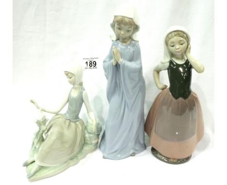 Two Nao figurines and a Lladro figurine of sitting girl, largest H: 23 cm. P&amp;P Group 2 (£18+VAT for the first lot and £3+