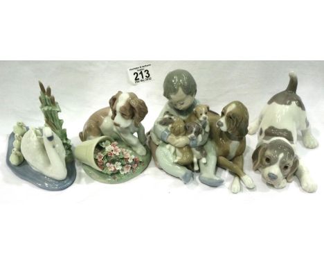 Four Lladro figurines to include dogs, largest H: 80 mm. Condition report: Possibly a couple of petal losses on the dog with 