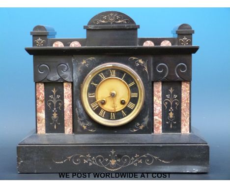 A French mantel clock in black slate case inlaid with pink marble, Roman numerals on black chapter ring offset with gilt dial