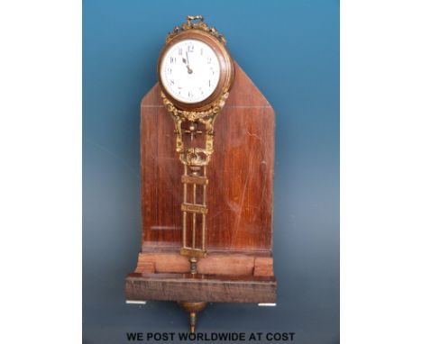 A pendulum clock in decorated metal floral and foliate case, with compensating type  pendulum and orb shaped bob, 24cm total 