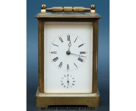 A brass carriage clock in original carry case, alarm mechanism striking on a bell