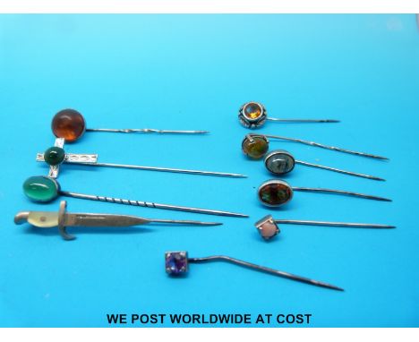 Eight white metal stick pins, set with amber, citrine, agate etc 