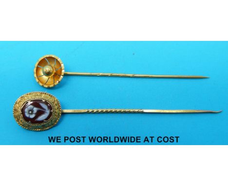 A Victorian stick pin marked 15ct and a Victorian yellow metal stick pin set with an agate cameo of a flower