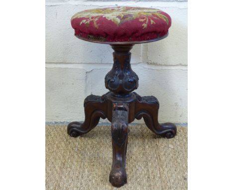 A revolving 19thC music stool with tripod base