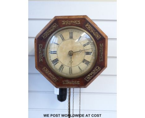 An octagonal brass inlaid pendulum wall clock