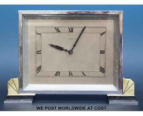 An 8 day Deco mantel clock in chrome plated rectangular case raised on faux onyx feet