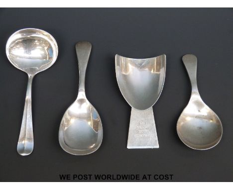 Three late 19thC / early 20thC hallmarked silver caddy spoons and a white metal example marked silver and engraved Barnes Lod