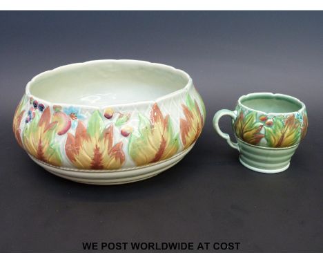 A Clarice Cliff leaf and berry fruit bowl (24cm diameter) together with a mug of the same design  