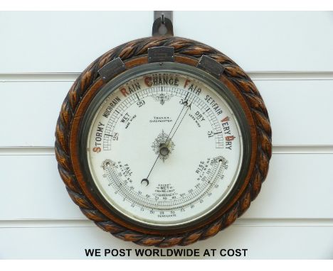 A. Tanner, Cirencester aneroid barometer with curved thermometer to lower dial, rope twist carving to case and three white me