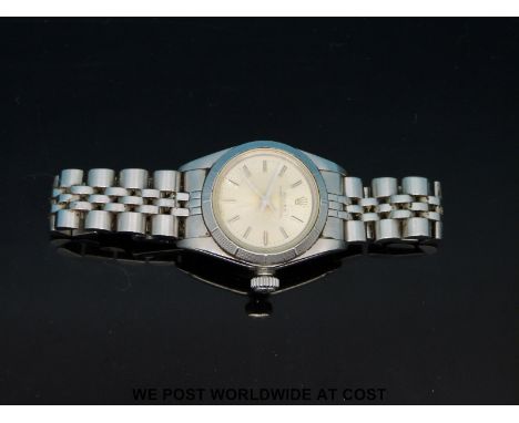 Rolex Oyster Perpetual ladies wristwatch with two-tone hands and baton numerals on stainless steel face. In stainless steel c