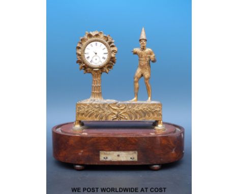 An early 19thC musical pocket watch stand  c1810 - 1820, comprising a decorative cast brass figure of Robinson Crusoe in typi