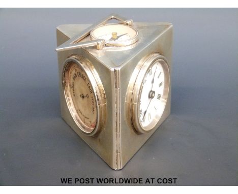 An Edward VII hallmarked silver cased clock, perpetual calendar, barometer and compass of triangular section with swing handl