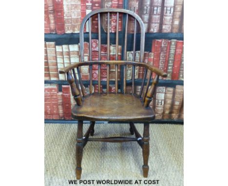 An antique child's stick back country Windsor carver chair with elm saddle seat 