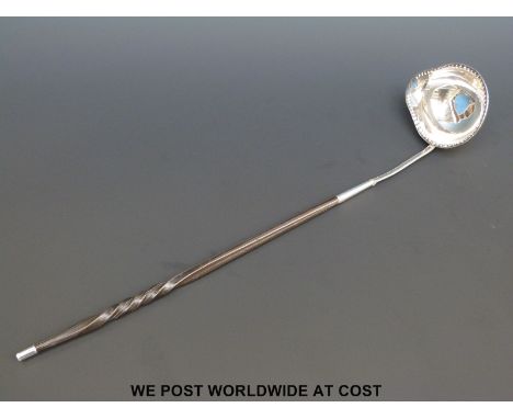 A Georgian white metal whalebone handled toddy ladle, engraved AR to lower handle, length 38cm