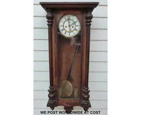 A two train Vienna wall clock with enamelled dial, Roman numerals, pierced hands and secondary seconds, two brass weights, th