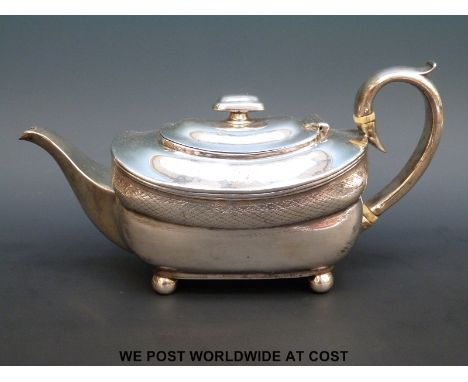 An Irish Georgian hallmarked silver bachelor's teapot, length 24cm, Dublin 1808, maker's mark rubbed (418g all in)