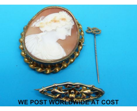 A cameo brooch depicting a classical figure, a yellow metal brooch and a yellow metal stick pin, both marked 9ct gold