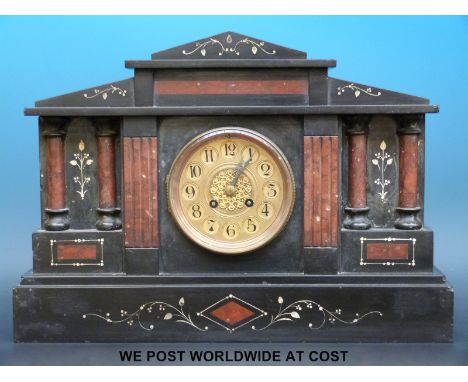 A two-train slate mantel clock inlaid with red marble Romanesque columned decoration and brass face, the movement striking on