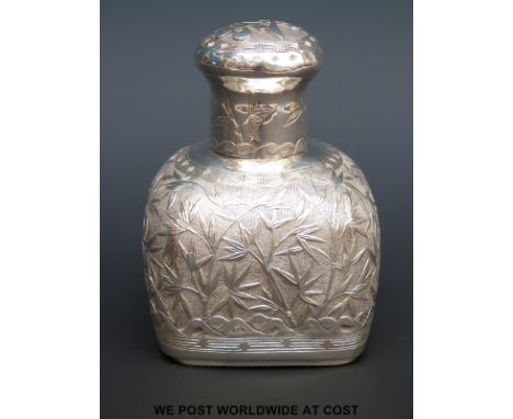 A Chinese white metal tea caddy with foliate decoration, height 11cm, Chinese silver marks to underside (158g)